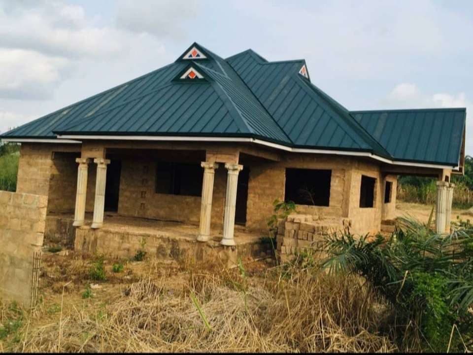 Completed green metal roof with entrance columns