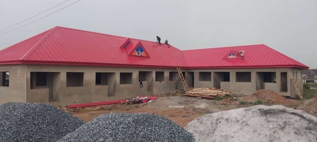 Red metal roof installation in progress